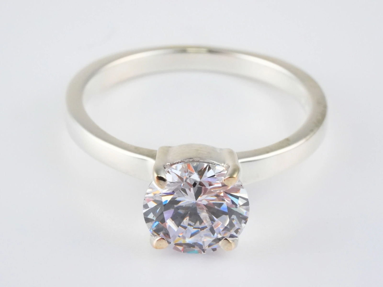 Lumina Promise Solitaire: classic four-prong silver ring with round-cut clear diamond