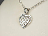 Luminous Heart 18k white gold pendant with intricate cut-out design