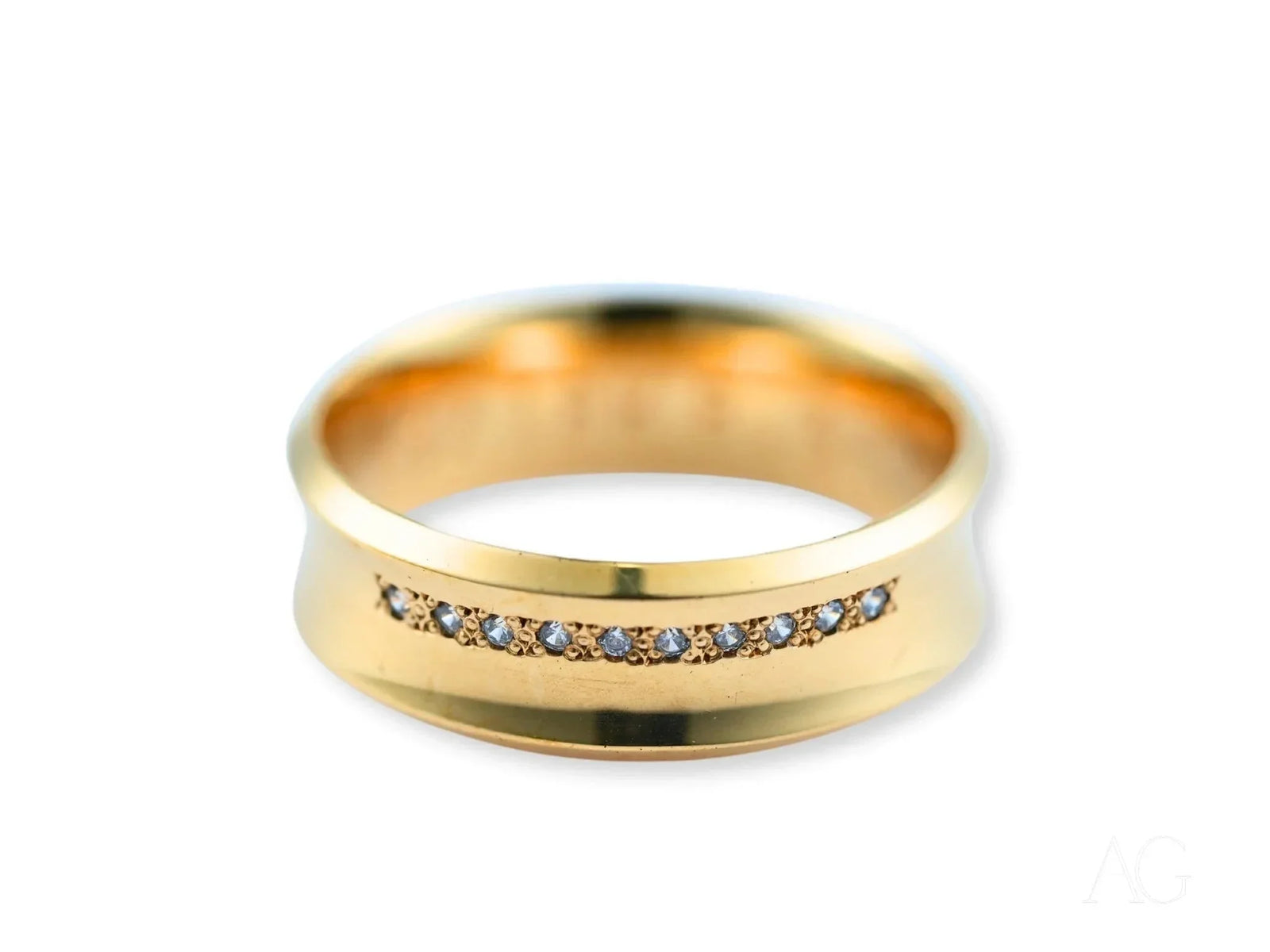 Angled side view of gold wedding band showing channel-set diamonds and curved profile