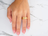 Top view of gold wedding band with linear diamond row and polished finish
