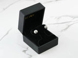 Pair of 18k white gold ball earrings in black velvet box