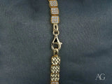 Luxurious solid 18k gold bracelet with alternating rows of pavé cubic zirconia and polished gold links, lobster clasp