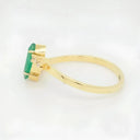 Luxurious 18k emerald marquise ring with rectangular gemstone