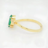 Luxurious 18k emerald marquise ring with rectangular gemstone