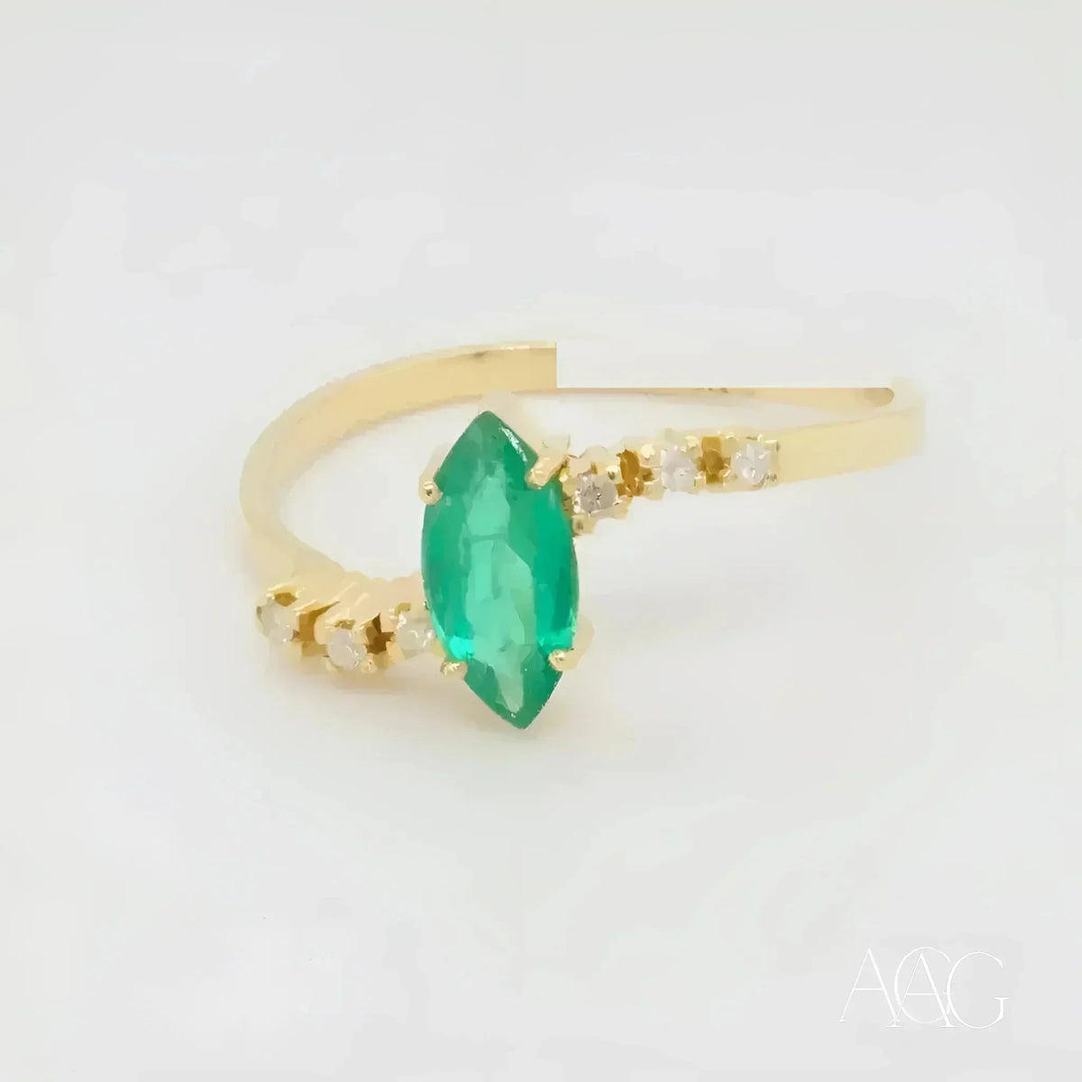 Luxurious 18k emerald marquise ring with diamond accents