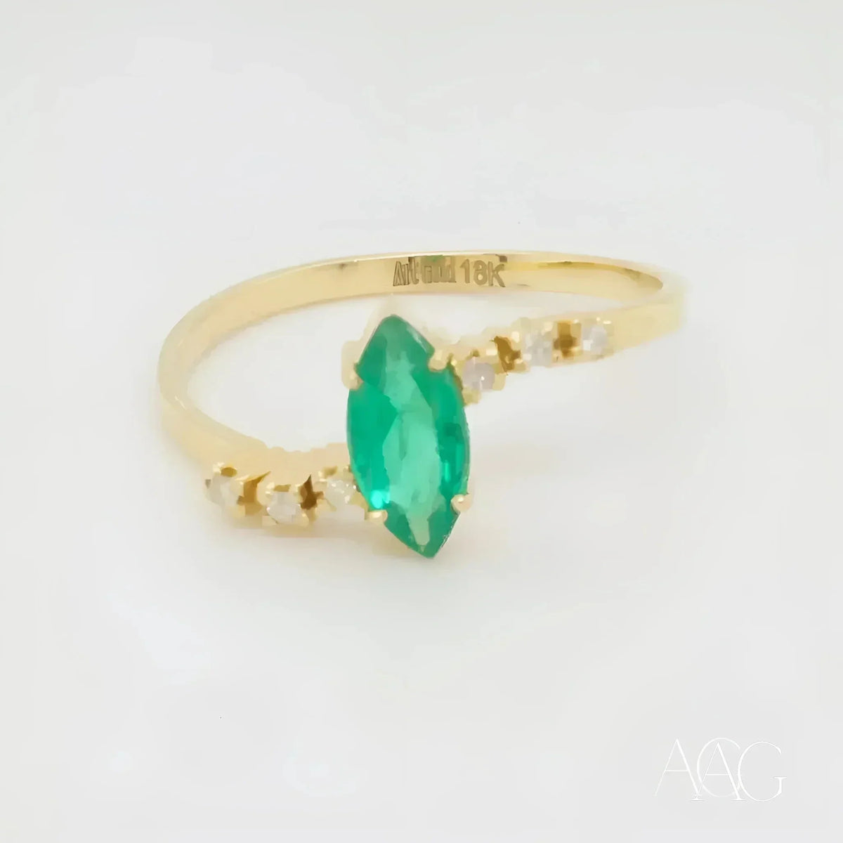 Luxurious 18k emerald marquise ring with diamond accents