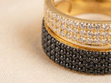 Macro close-up of Sophisticated contrast 18K gold ring showing white CZ in upper band and black CZ in lower band