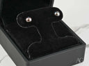 Midnight Elegance black pearl stud earrings on velvet stand