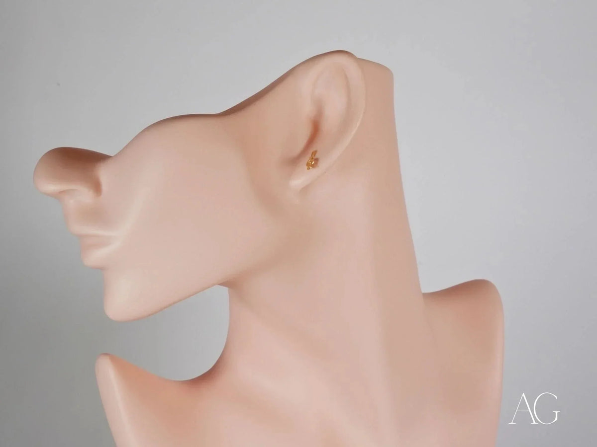 Elegant certified 18k solid gold music note earring on ear mannequin