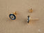 Gold stud earrings with blue and white enamel evil eye design in Mystic Protection art gold jewelry