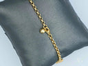 Exquisite 18k gold charm bracelet with nautical elegance and spherical charm