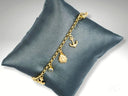 Exquisite 18k gold charm bracelet with nautical elegance anchor, ladybug, and gemstone charms
