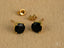 Black onyx stud earrings with 18K gold settings and earring backs for elegant style