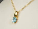 Ocean Breeze Pendant: gold necklace with oval blue topaz gem