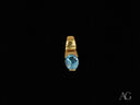 Ocean Breeze Pendant: Oval Blue Topaz in Art Gold Jewelry