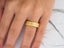 Matte gold Orbit Lines wedding band with inset diamonds and comfort fit design
