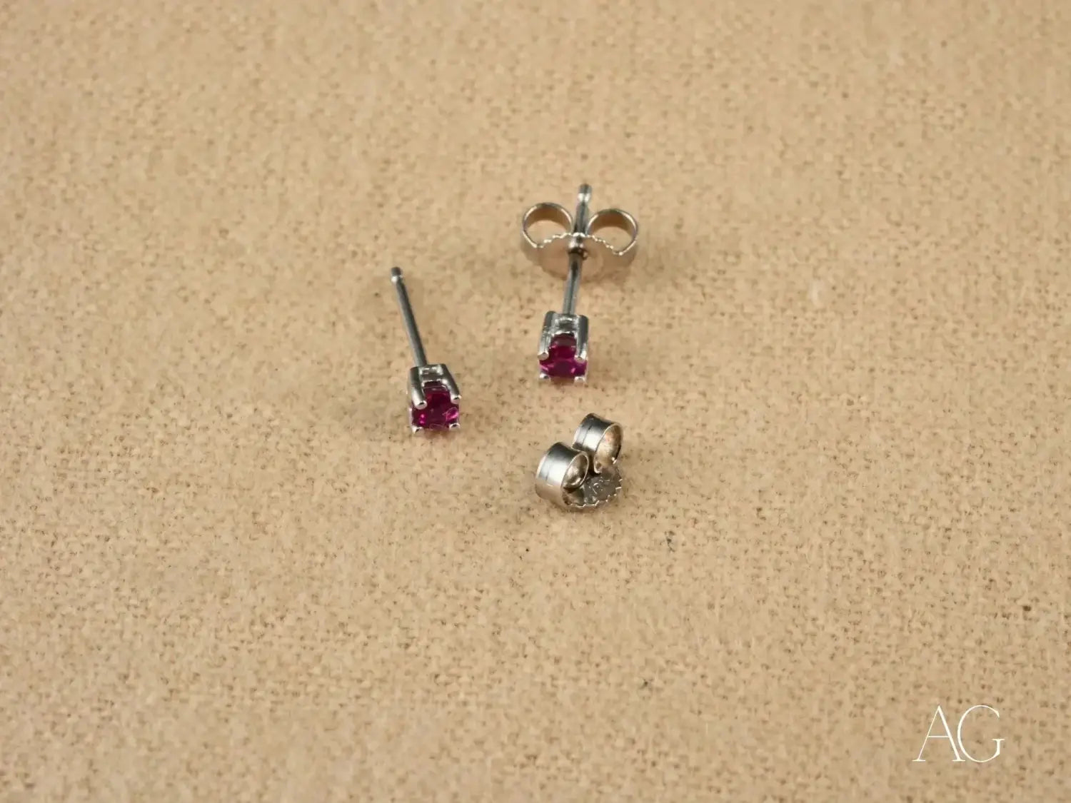 Elegant Graff Diamonds red stud earrings with silver clasp view.