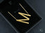 Gold-colored zig-zag shaped dangle earrings in a black box, perfect with personalized necklace and 18k gold jewelry