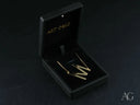 Gold-toned bar earrings in black velvet box with 18k gold jewelry