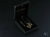 Gold-toned bar earrings in black velvet box with 18k gold jewelry