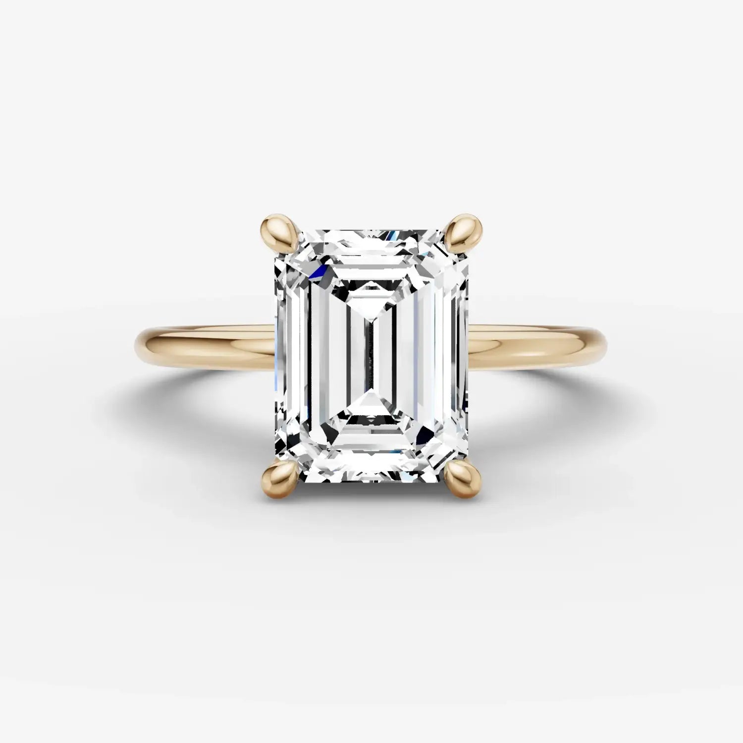 A regal gold crown jewel adorned with intricate detailing, emerald stones, and sparkling diamonds in fine gold jewelry.
