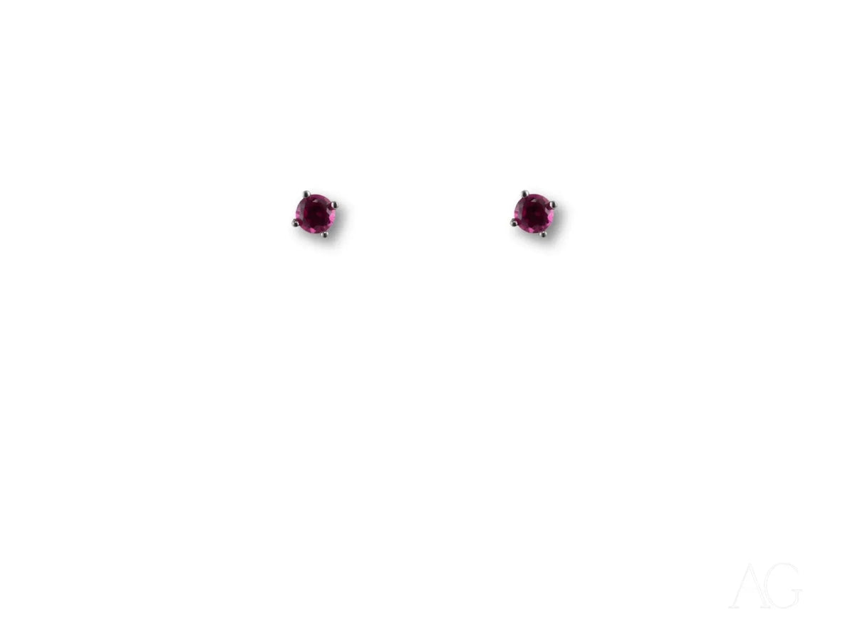 Pair of 18k white gold CZ stud earrings with dark red gemstones