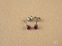 18k white gold CZ stud earrings with fuchsia round-cut gems