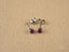 Silver stud earrings with round-cut fuchsia gemstones in 18k white gold jewelry style