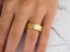 Polished gold Radiant Harmony Wedding Band with two small diamonds and curved design