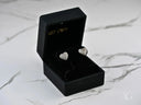 Radiant Love luminous 18k gold heart earrings in black box