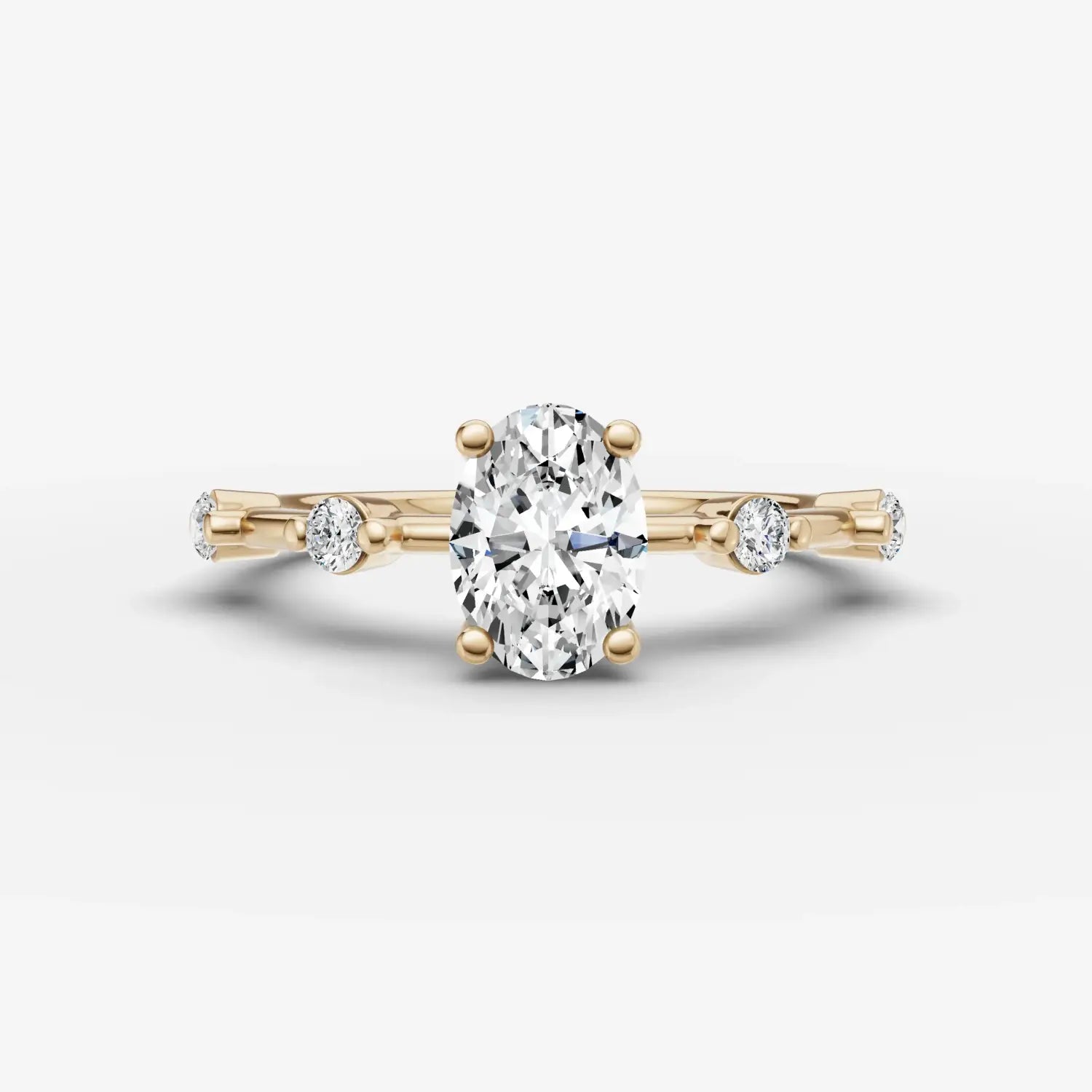 A hand wearing multiple gold-toned sculptural rings and a matching chain bracelet showcasing art gold jewelry.