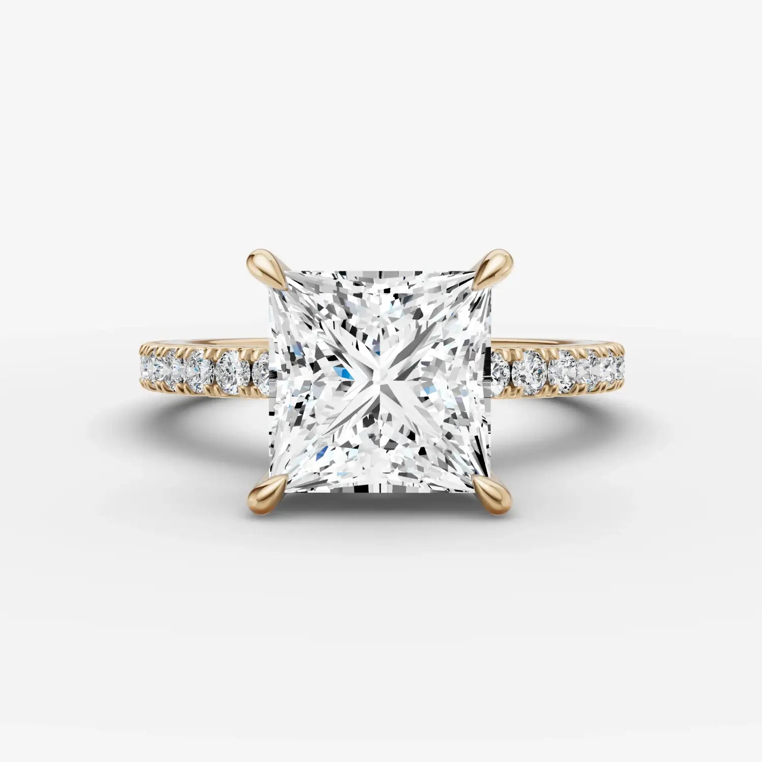 A collection of 18k gold rings featuring smooth and engraved designs with a white stone inlay in fine jewelry style.