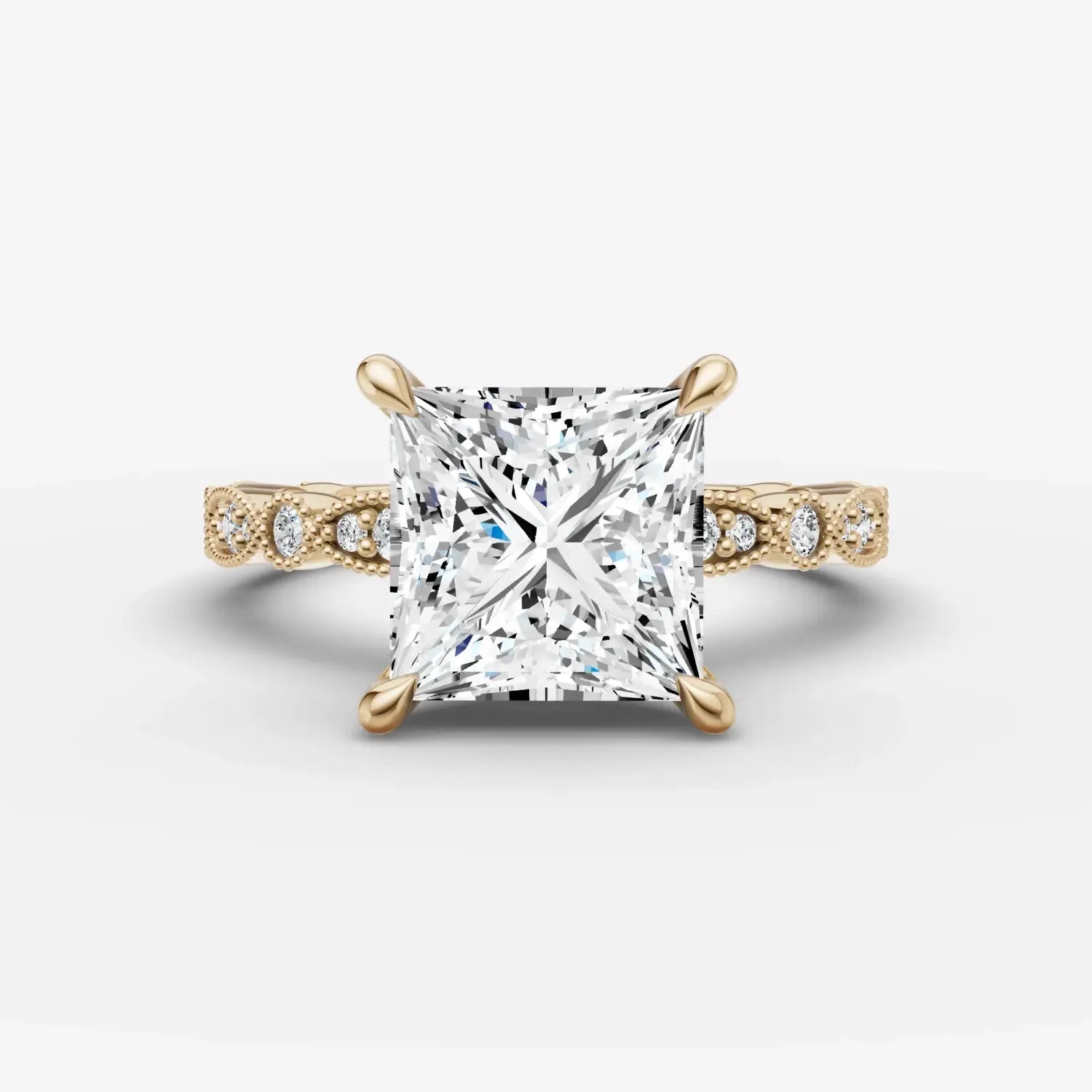A hand wearing multiple gold-toned sculptural rings and a matching chain bracelet showcasing art gold jewelry.