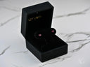 Black velvet box with ruby-red CZ heart earrings in 18k gold
