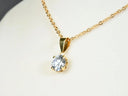 Radiant solitaire pendant in art gold jewelry with round-cut diamond
