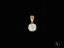 Radiant Solitaire Pendant featuring a round brilliant-cut diamond in art gold jewelry setting