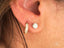 Elegant ear with Radiate Love Mini Hoops Earrings in 18k yellow gold art gold jewelry