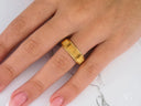 Regal Ridge gold wedding band with ribbed design on finger