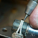 Jeweler repairs diamond-encrusted ring with art gold jewelry in Greater Boston area