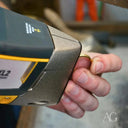 Handheld metal analyzer testing gold ring for art gold jewelry repair in Greater Boston Area