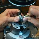 Art gold jewelry repair vise holding intricate metal piece in Greater Boston area