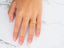 Royal Crest art gold jewelry featuring a gold band ring with textured accents and embedded crystals on a finger