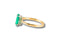 Gold ring with oval emerald and diamond accents showcasing cubic zirconia sophistication