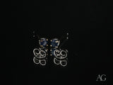 18k white gold sapphire earrings with silver studs and dark blue gems