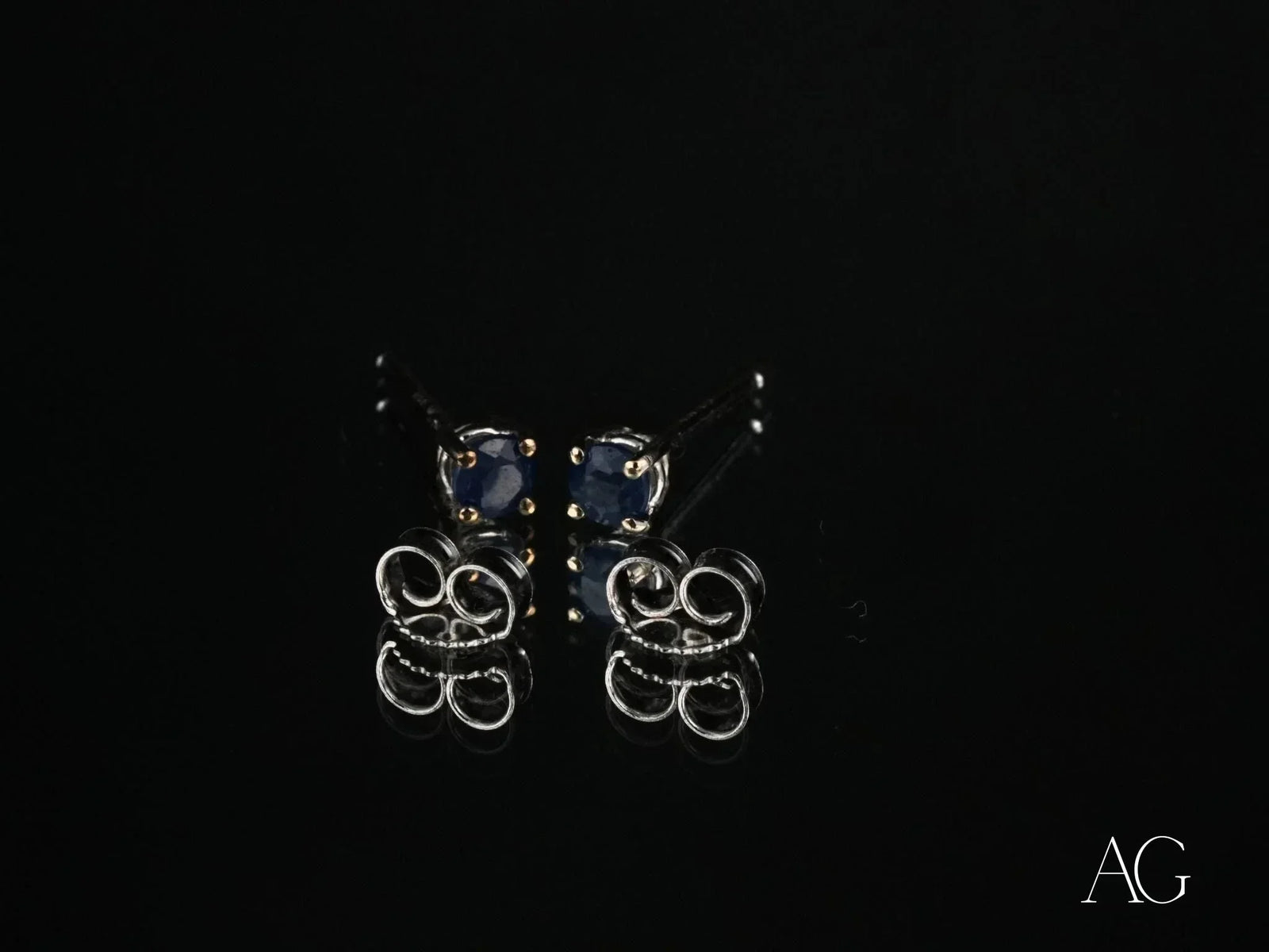 18k white gold sapphire earrings with silver studs and dark blue gems