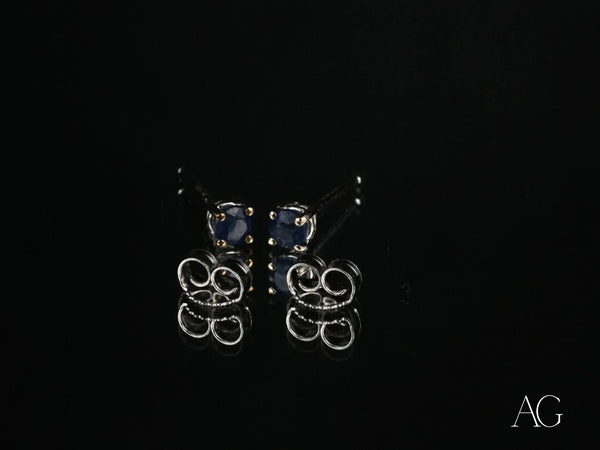 18k white gold sapphire earrings with silver studs and dark blue gems