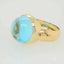 Gold ring featuring a large cabochon blue topaz gemstone in Serenity in Blue design