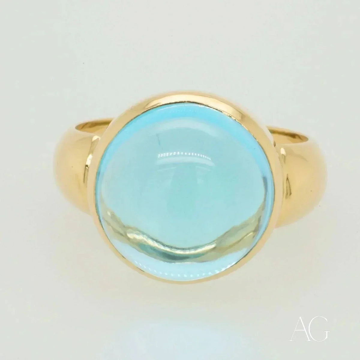 Polished gold Serenity in Blue cabochon blue topaz ring