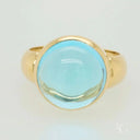 Polished gold Serenity in Blue cabochon blue topaz ring