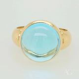 Polished gold Serenity in Blue cabochon blue topaz ring